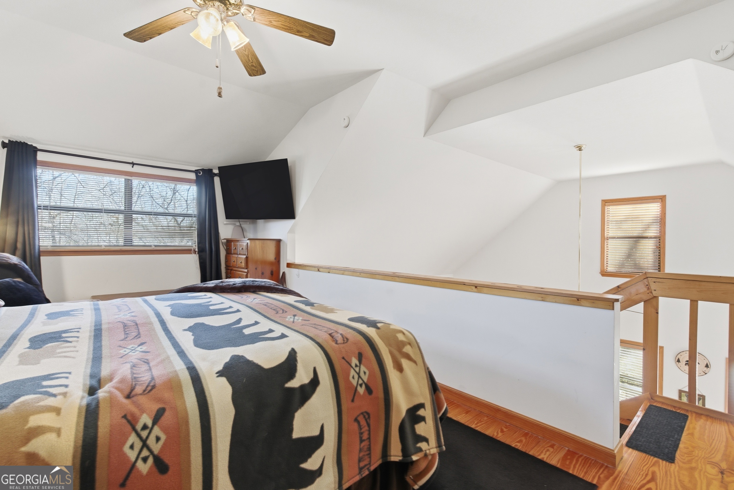 1637 Townsend Mill Road Young Harris, GA 30582 - Photo 24 of 57 a bedroom with a bed and a flat tv screen on the dresser