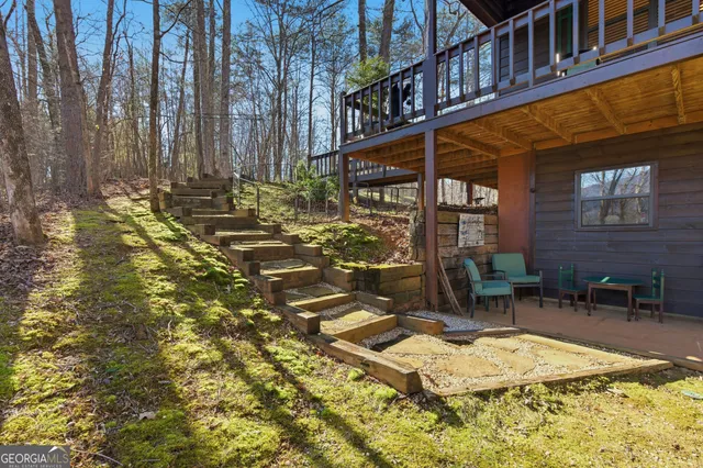 a view of a house with backyard and sitting area