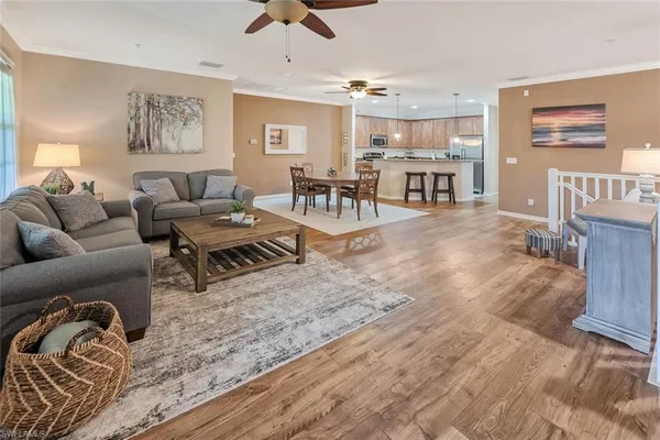 a living room with furniture and kitchen view