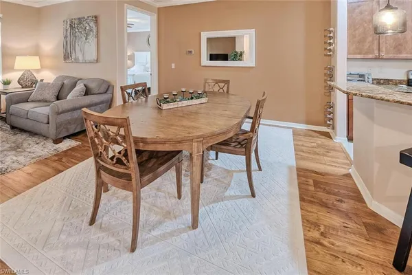 a view of a dining room with furniture and wooden floor