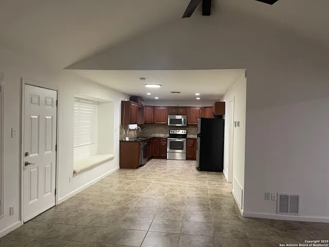 a kitchen with refrigerator and window