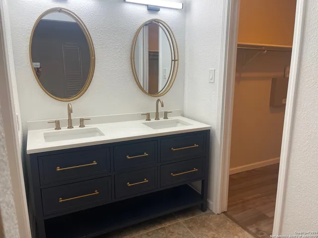 a bathroom with a double vanity sink and a mirror