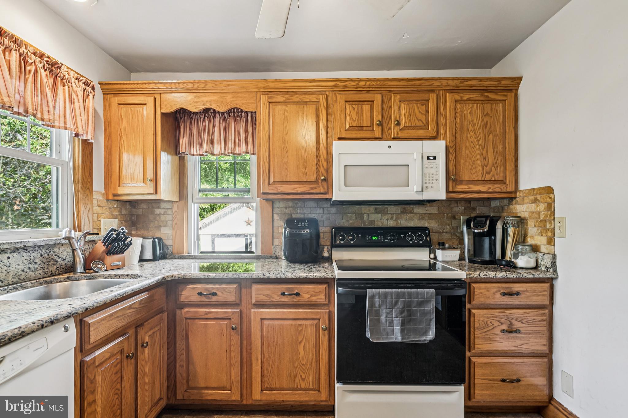 19 Sickler Street Quinton, NJ 08079 - Photo 11 of 25 a kitchen with stainless steel appliances granite countertop a stove a sink and a microwave