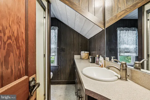 a bathroom with a sink a mirror and a bathtub