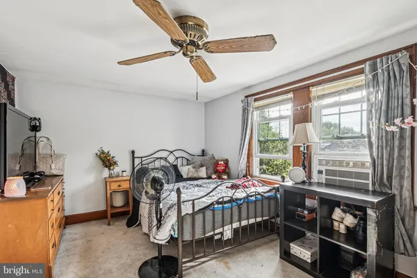 a bedroom with furniture and a window