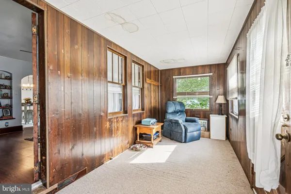 a living room with furniture and large windows