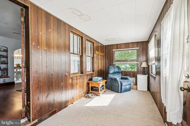 a living room with furniture and large windows