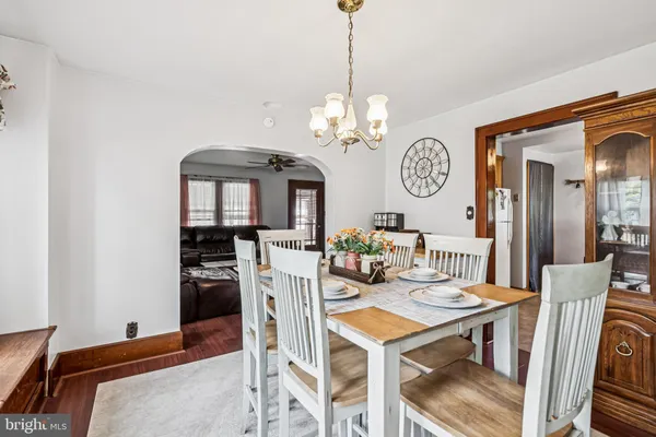 a view of a dining room with furniture and a chandelier