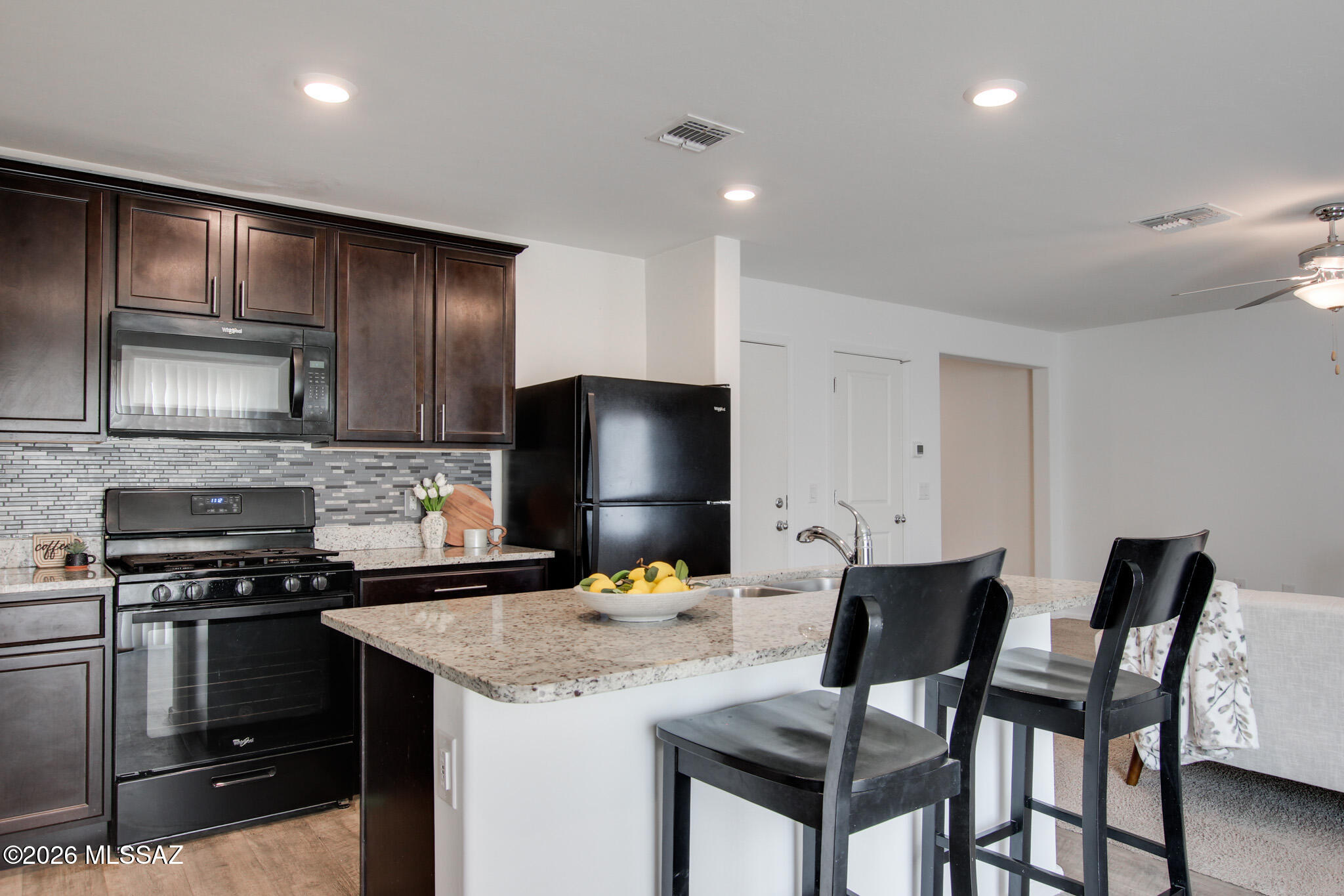 5987 South Antrim Loop Tucson, AZ 85706 - Photo 12 of 34 a kitchen with a stove a sink and a refrigerator