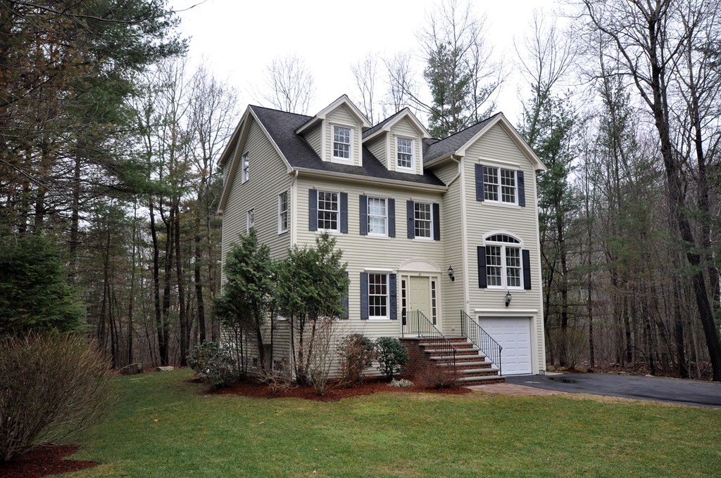 40 Battle Flagg Road Bedford, MA 01730 - Photo 26 of 30 a front view of a house with a garden and yard