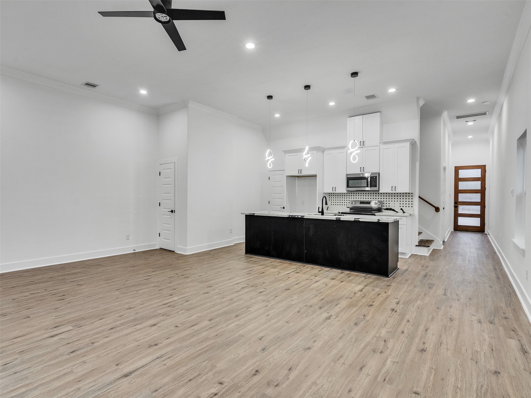 6014 Grace Lane, Unit A/B Houston, TX 77021 - Photo 19 of 36 a large white kitchen with kitchen island a sink dishwasher a stove and a refrigerator with wooden floor
