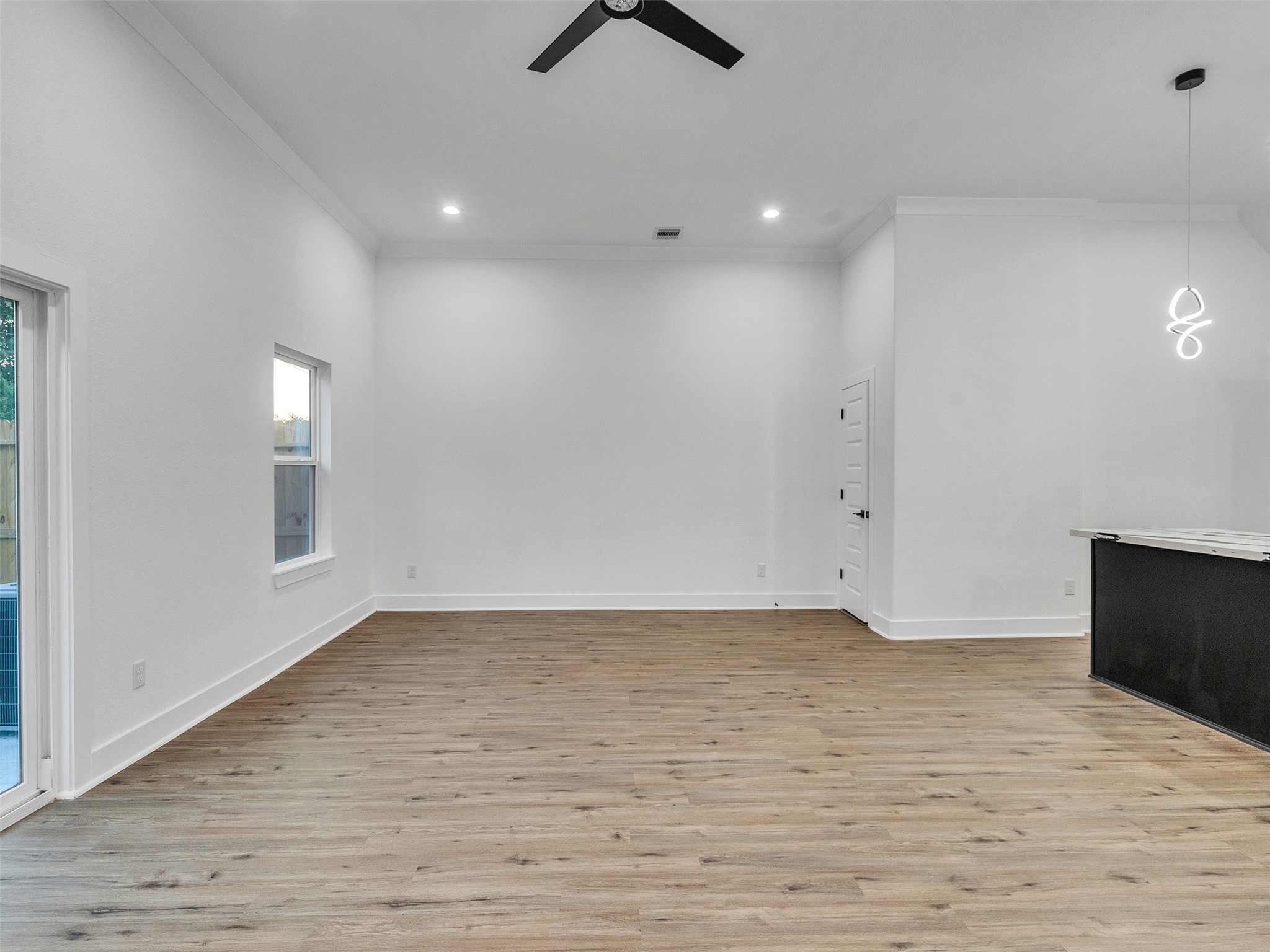 6014 Grace Lane, Unit A/B Houston, TX 77021 - Photo 20 of 36 an empty room with wooden floor and windows