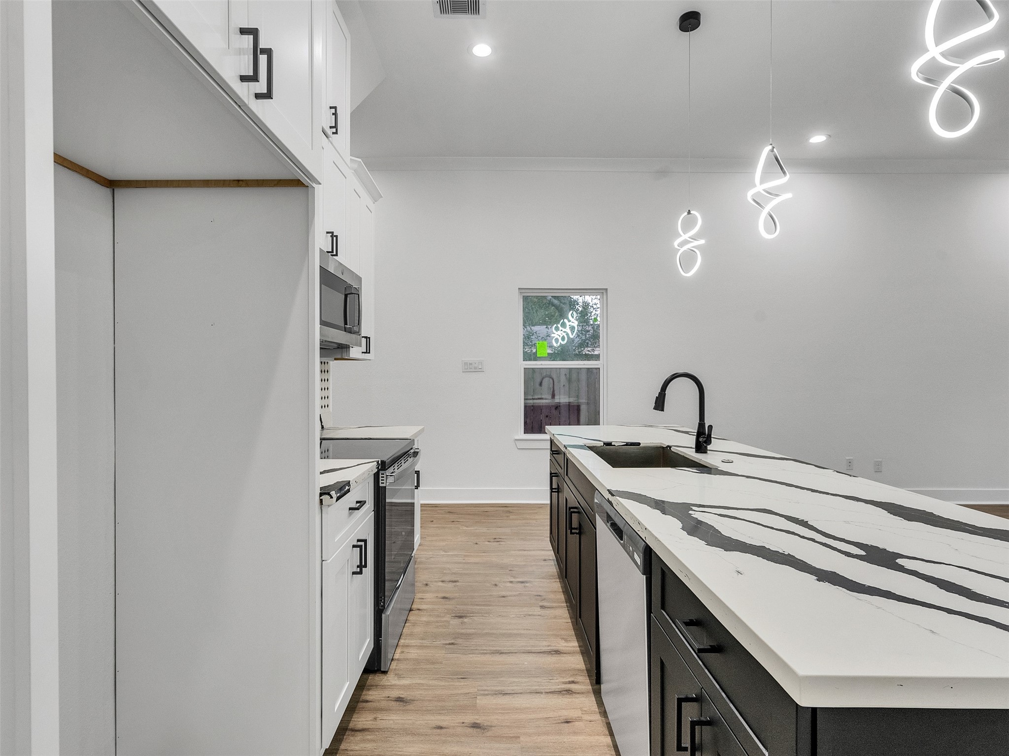 6014 Grace Lane, Unit A/B Houston, TX 77021 - Photo 24 of 36 a kitchen with a sink and wooden floor