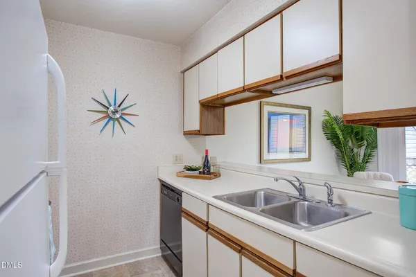 a kitchen with a sink a cabinets and window