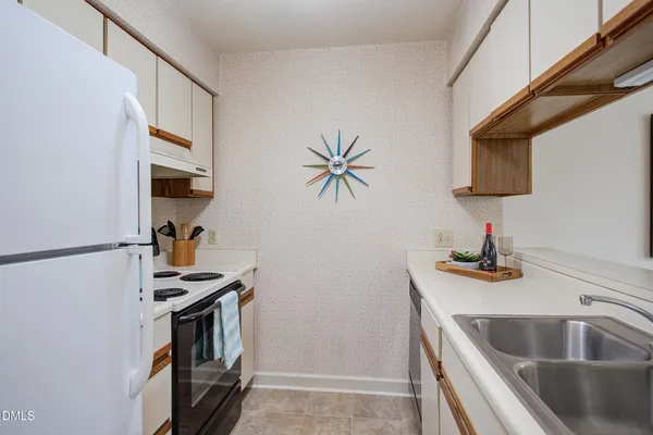 a kitchen with a refrigerator and a sink