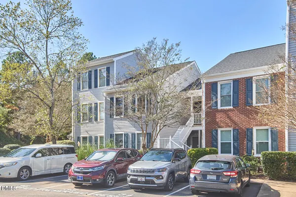 a front view of a residential apartment building with a yard