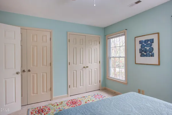 a bedroom with windows