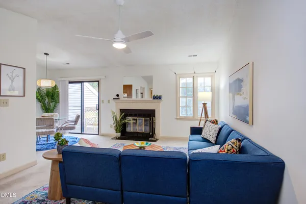 a living room with furniture a flat screen tv and a fireplace