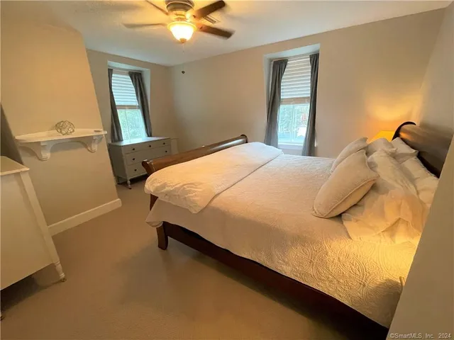 a bedroom with a bed and window