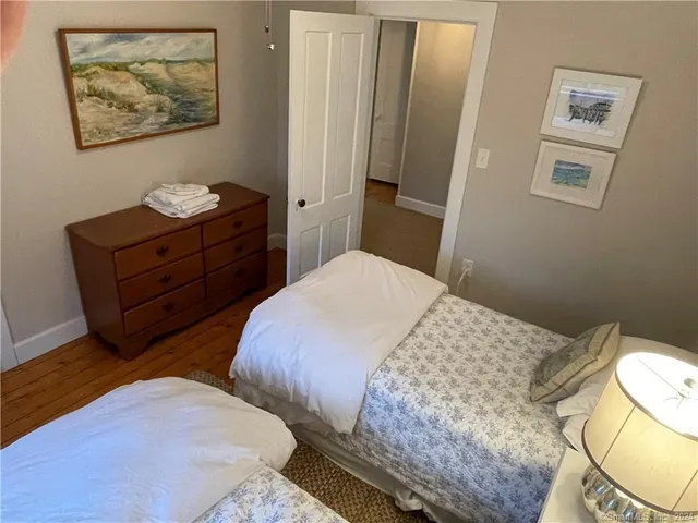 a bedroom with a bed and the view of bathroom