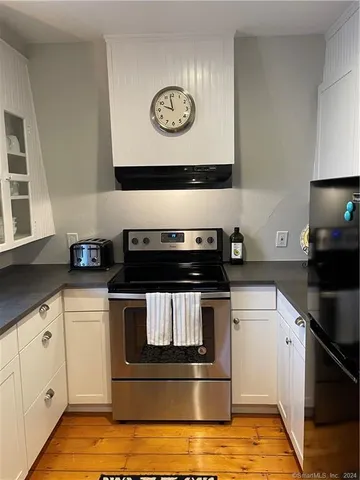 a kitchen with stainless steel appliances granite countertop a stove and a sink
