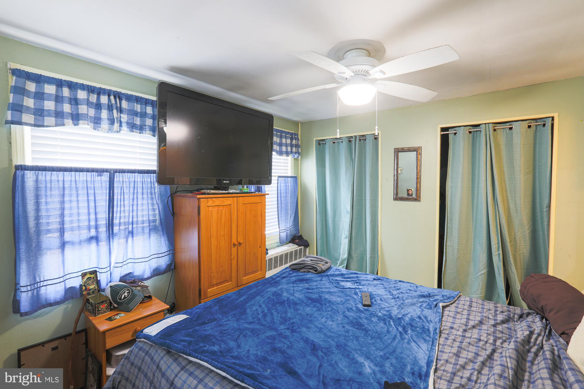 1225 Neighbors Avenue Rosedale, MD 21237 - Photo 18 of 33 a bedroom with a bed and a flat screen tv