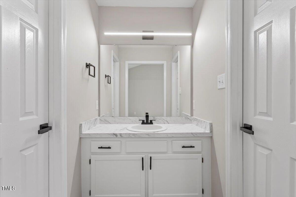 1480 White Memorial Church Road Willow Spring, NC 27592 - Photo 17 of 23 a sink with a mirror