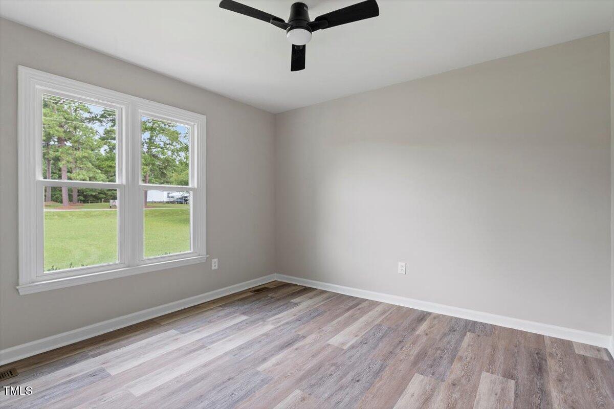 1480 White Memorial Church Road Willow Spring, NC 27592 - Photo 19 of 23 a view of a room with wooden floor and windows