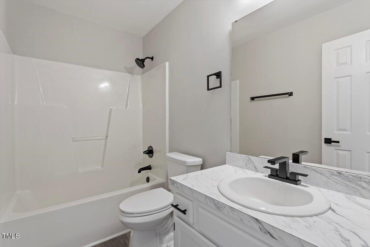 1480 White Memorial Church Road Willow Spring, NC 27592 - Photo 20 of 23 a bathroom with a sink a toilet and shower