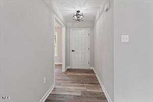 1480 White Memorial Church Road Willow Spring, NC 27592 - Photo 3 of 23 a view of a hallway with wooden floor