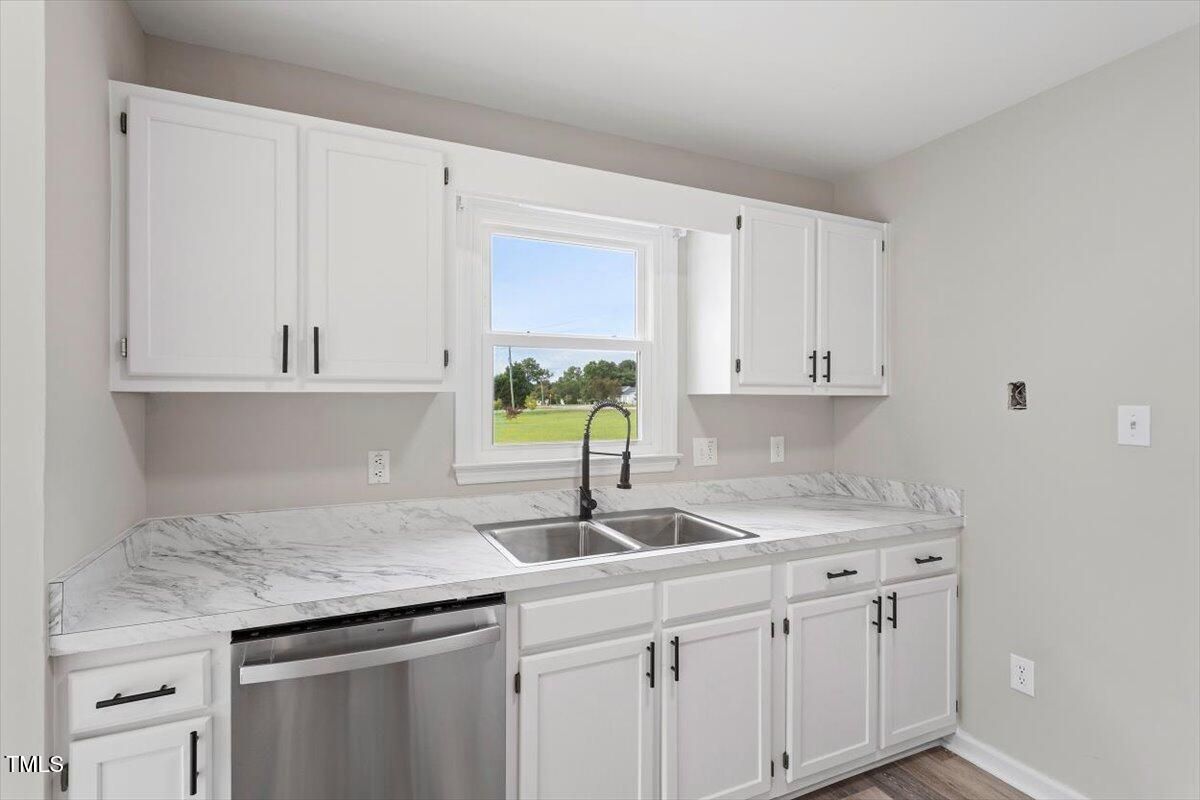 1480 White Memorial Church Road Willow Spring, NC 27592 - Photo 8 of 23 a kitchen with white cabinets and a sink