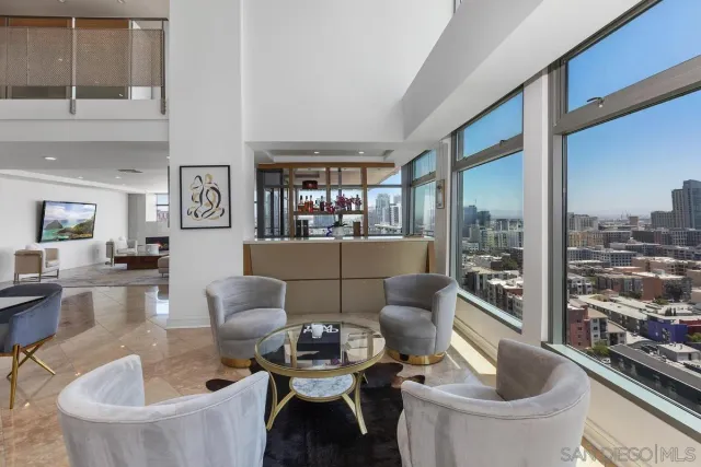 a living room with furniture and a floor to ceiling window