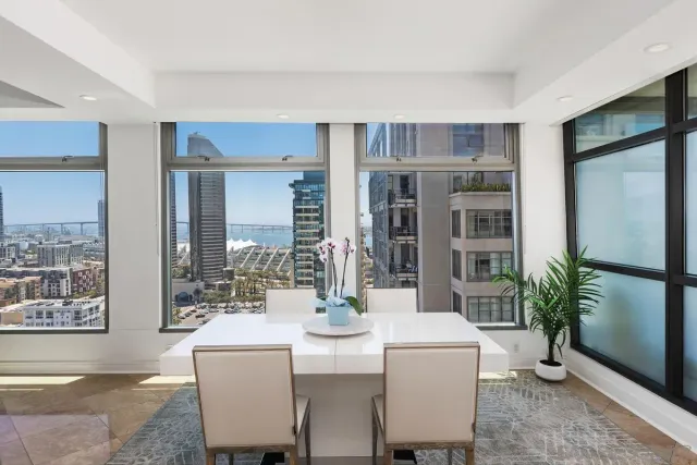 a kitchen with granite countertop a stove a sink and a white cabinets