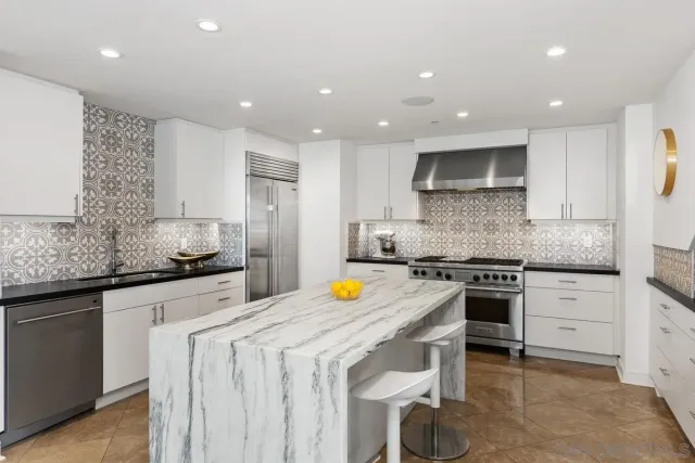 a bedroom with a bed couch and windows