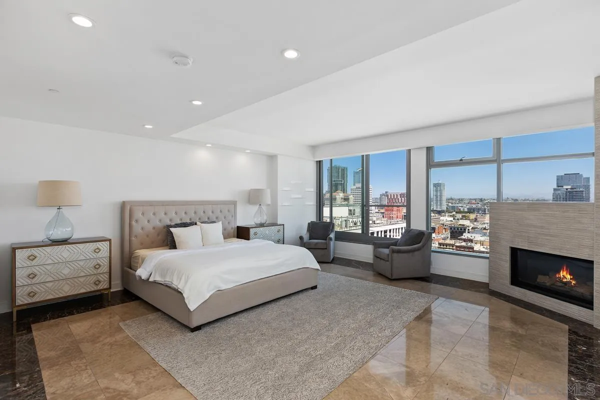645 Front Street, Unit 2004 San Diego, CA 92101 - Photo 22 of 47 a bedroom with a bed couch and windows