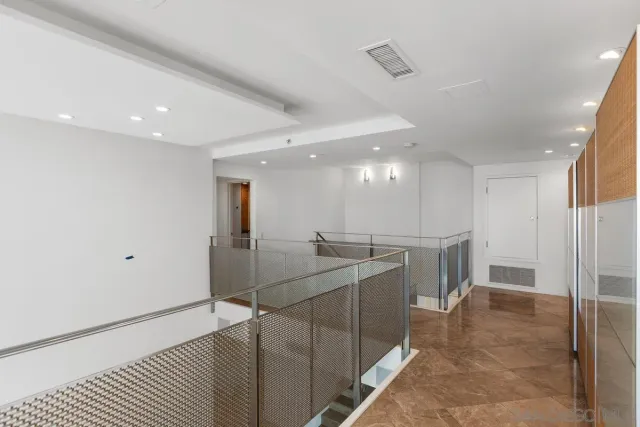 a living room with furniture large windows and a rug