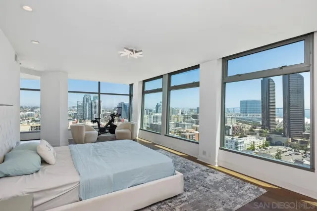 a living room with furniture and a floor to ceiling window