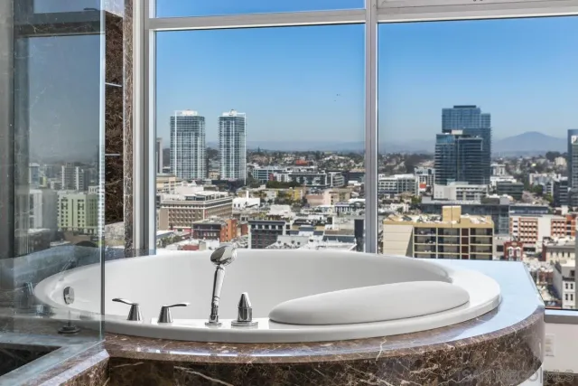 a spacious bedroom with a large bed and a large window