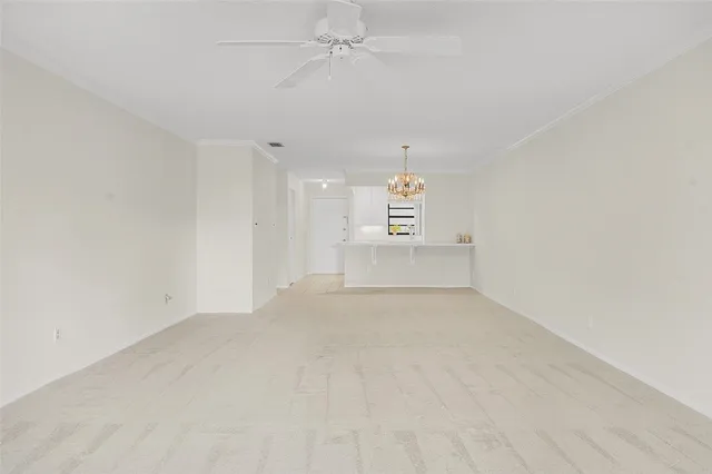 an empty room with a empty space and a ceiling fan