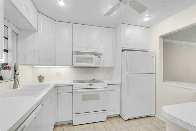 a view of a kitchen with white cabinets