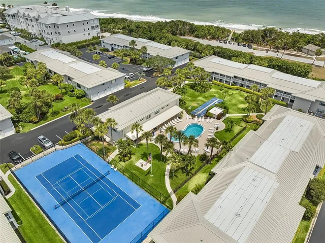 an aerial view of a residential houses with outdoor space