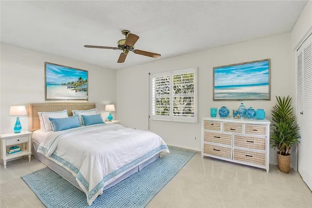 a bedroom with a bed a dresser and a window