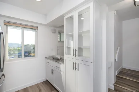 a kitchen with cabinets and window