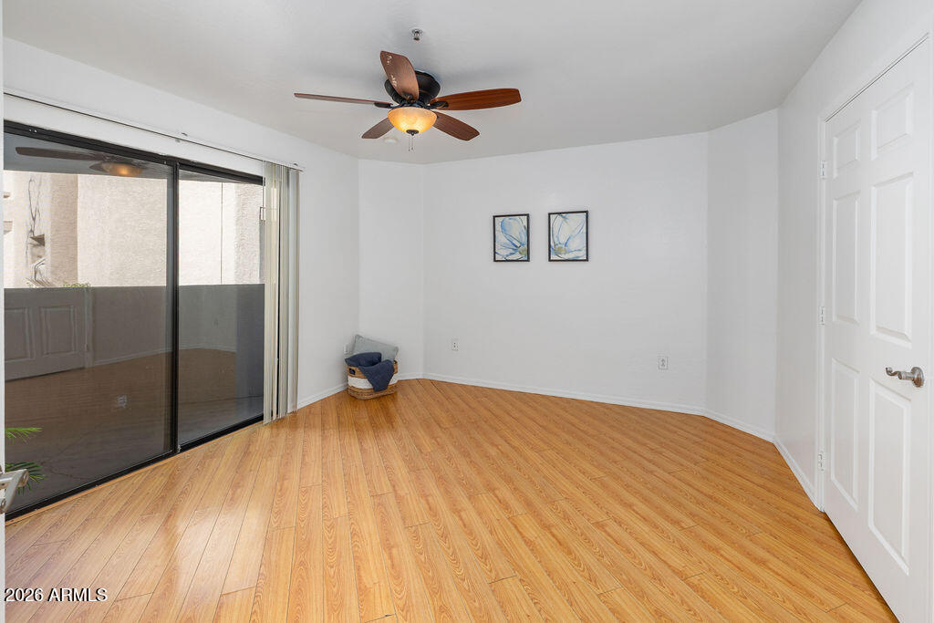 1287 North Alma School Road, Unit 123 Chandler, AZ 85224 - Photo 12 of 26 a bedroom with a bed and a large window