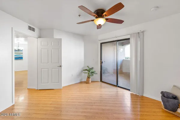 a view of an empty room with wooden floor