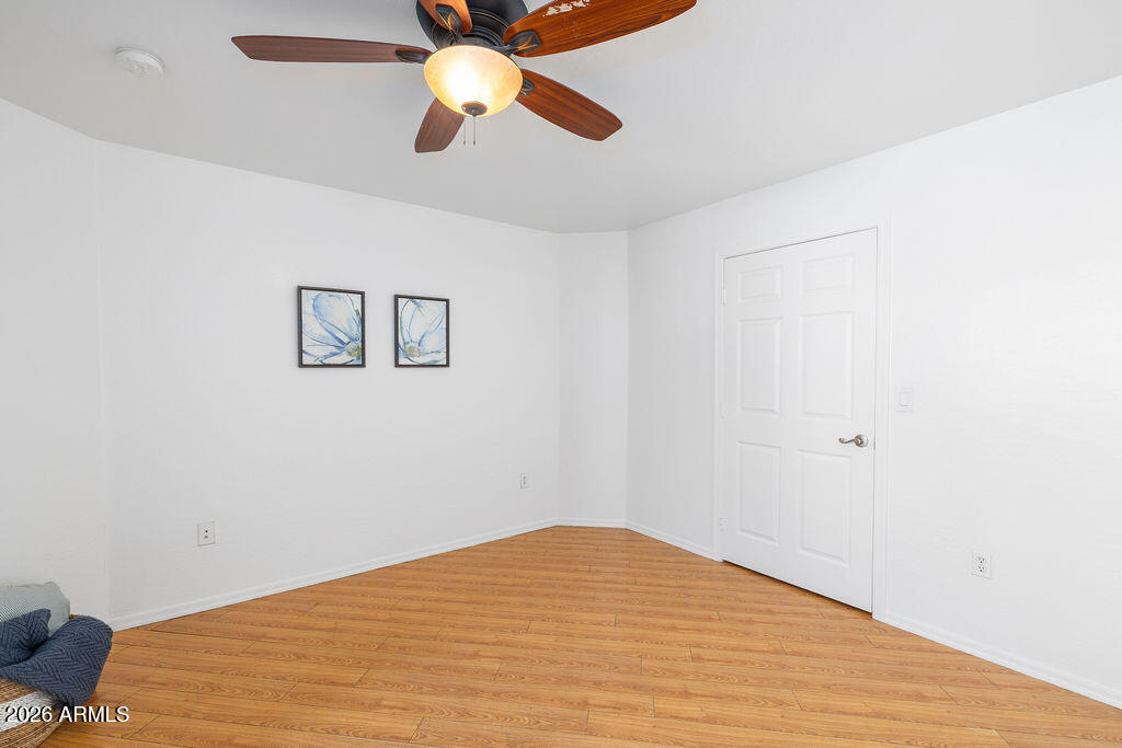 1287 North Alma School Road, Unit 123 Chandler, AZ 85224 - Photo 15 of 26 a bedroom with a bed and a chandelier