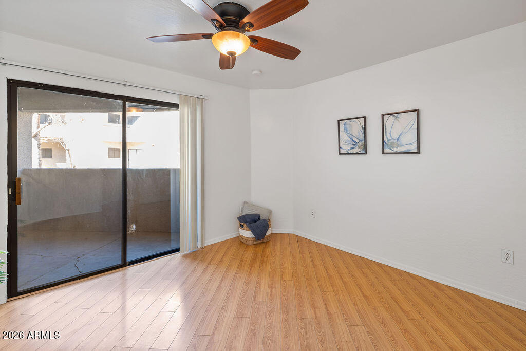 1287 North Alma School Road, Unit 123 Chandler, AZ 85224 - Photo 16 of 26 a bedroom with a bed and a chandelier