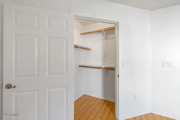 an empty room with windows and closet