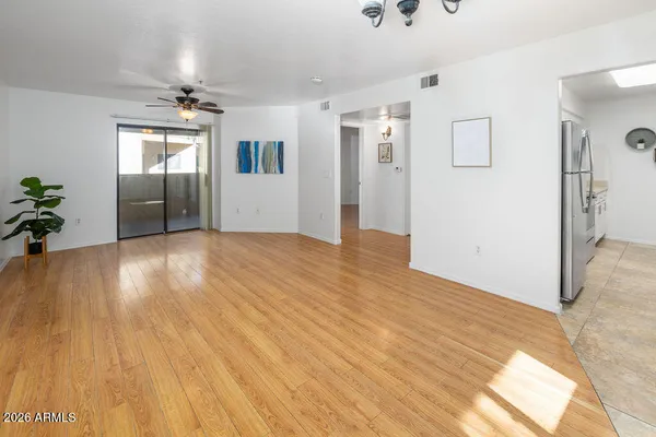 a view of empty room with wooden floor