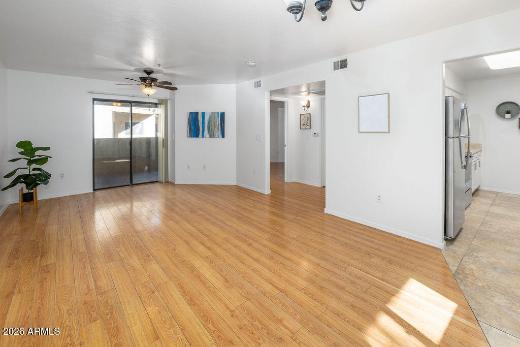 1287 North Alma School Road, Unit 123 Chandler, AZ 85224 - Photo 3 of 26 a view of a livingroom with wooden floor